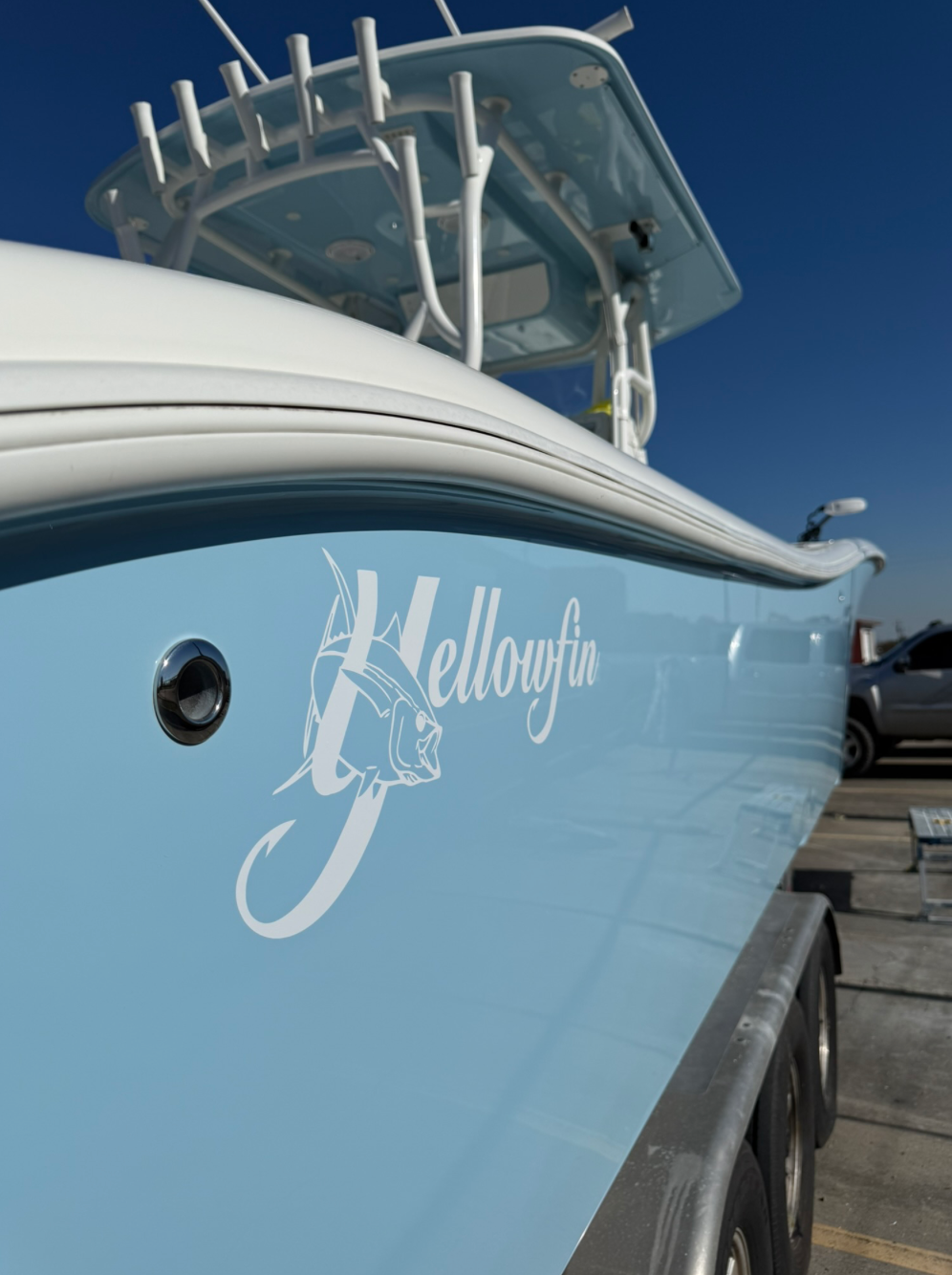 Yellowfin boat hull with a clean reflective finish after marine detailing