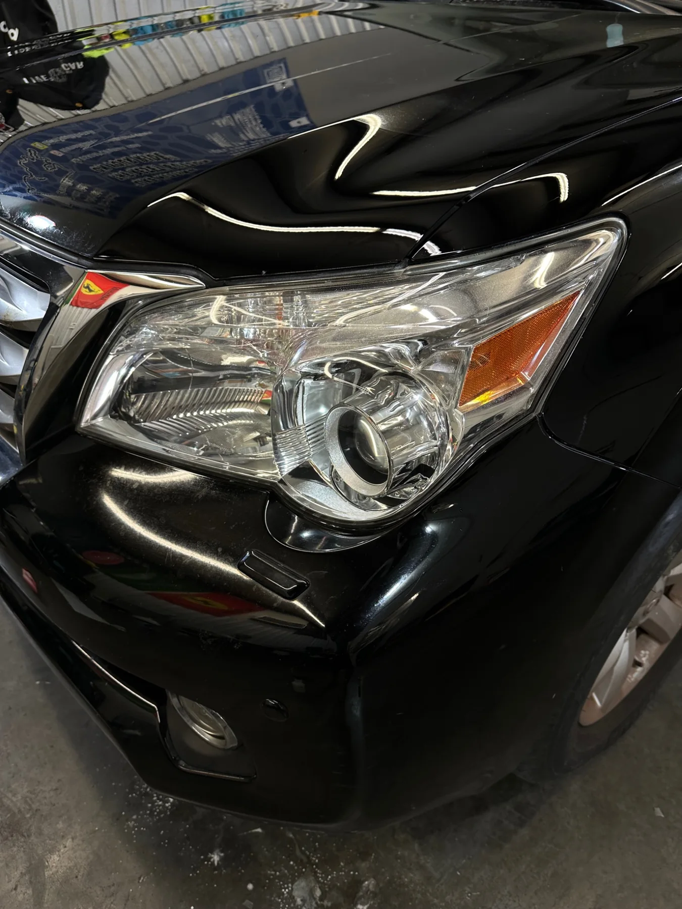 Same black Lexus after paint correction and headlight restoration