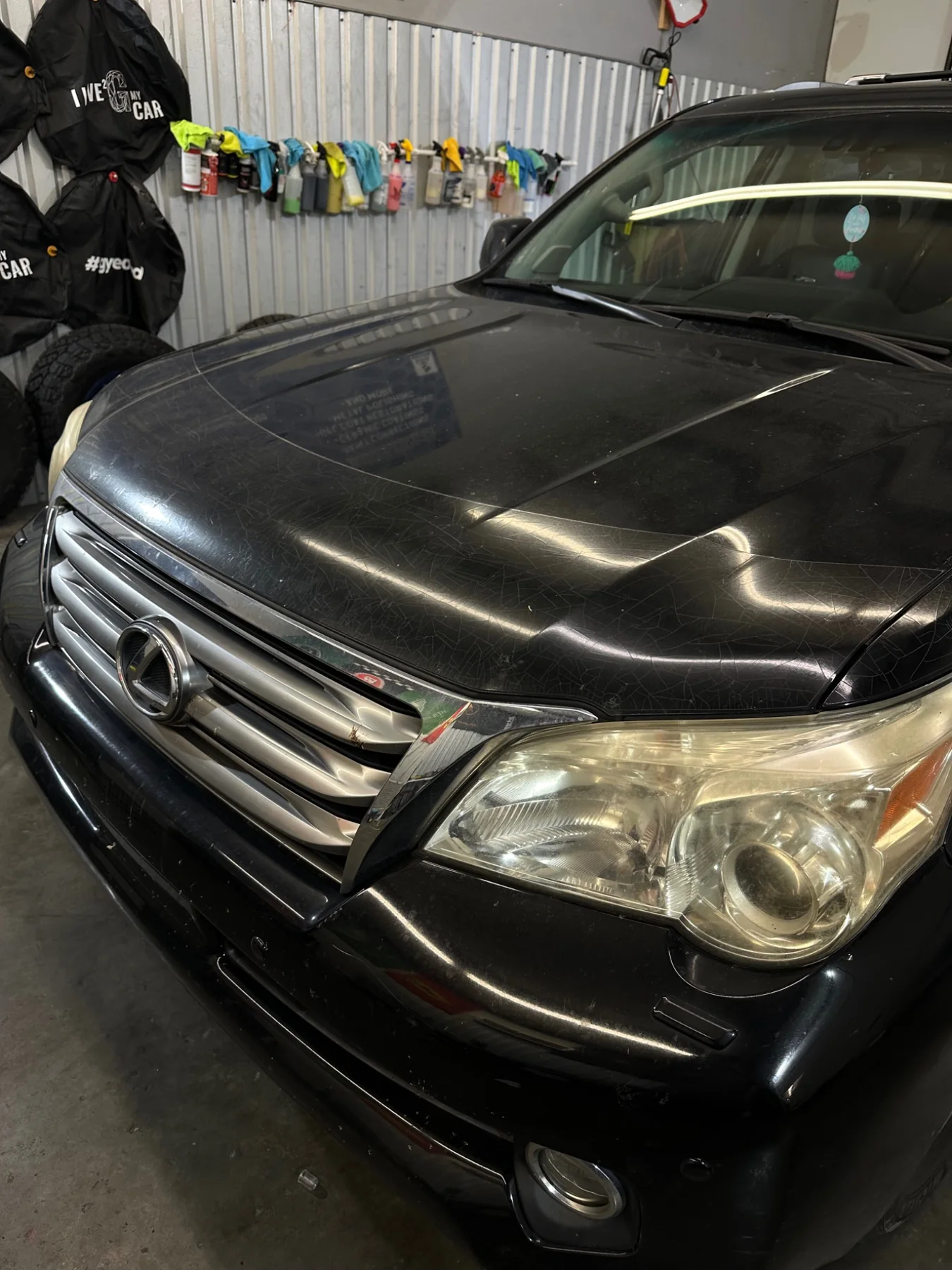Black Lexus before paint correction with hazy finish and cloudy headlight